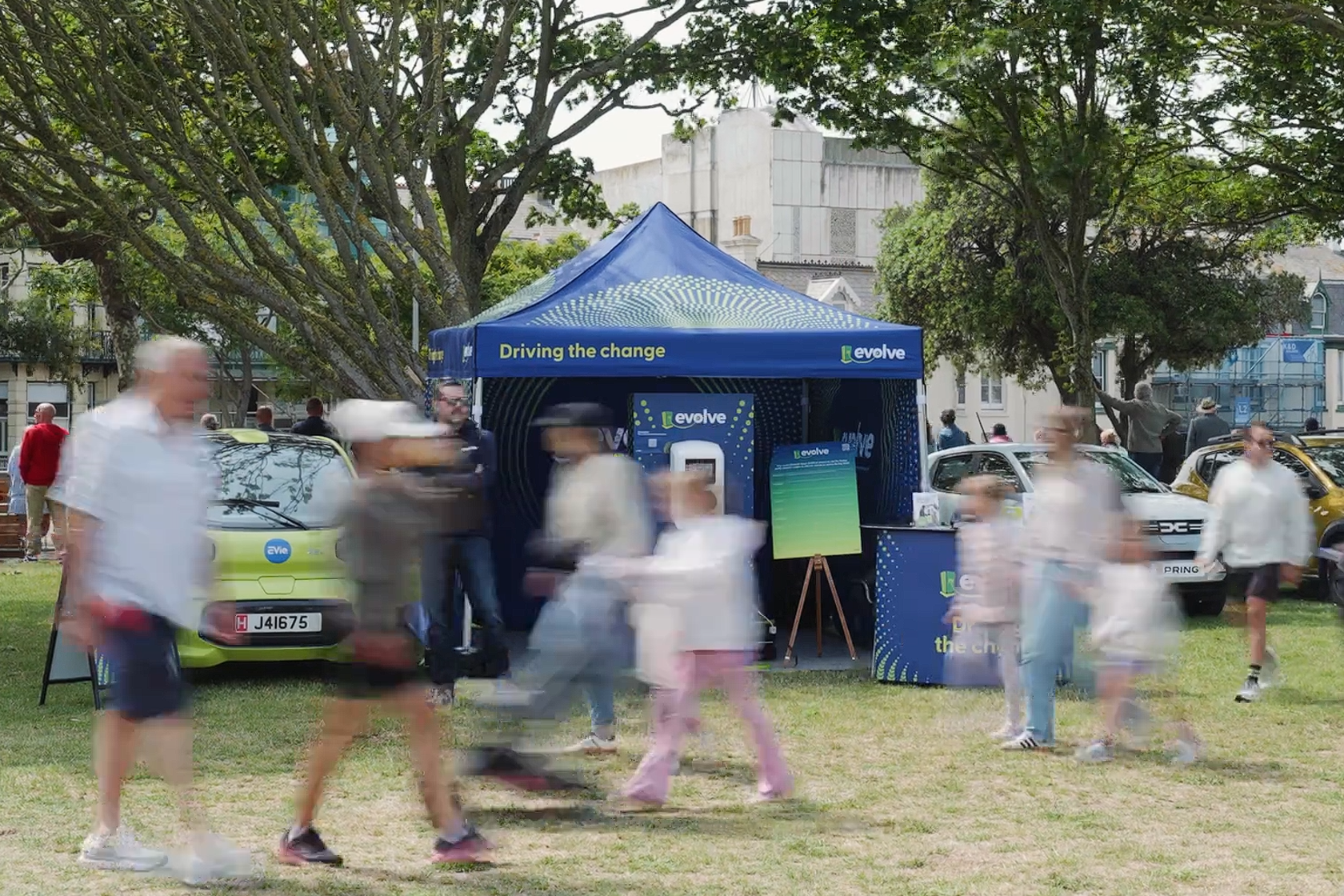 People walking past a blue 
